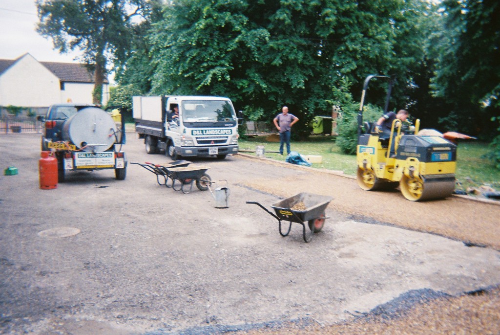 Laying hot bitumen tar and embedding the pea shingle.